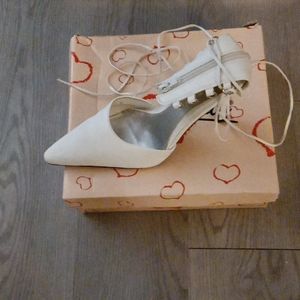 Lace up and zip up white high heel shoes
